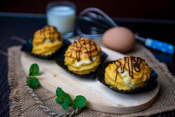 Kue soes coklat, soes coklat, chocolate cream puffs or famous with Choux Pastry Cream Puffs, pastry ball filled with white cream