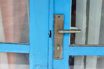 a close up of a vintage door knob on a wooden door