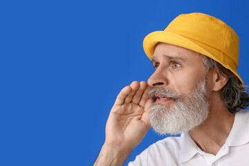 Stylish mature man on color background