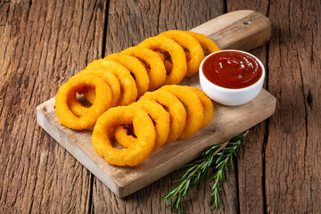 Crispy onion rings with ketchup.