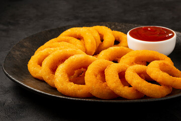 Crispy onion rings with ketchup.