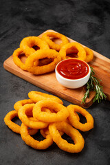 Crispy onion rings with ketchup.