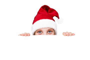 a child in a Christmas hat peeks out from behind a white background. isolated on white background. Place for your text.
concept of christmas sales and discounts. Surprises 