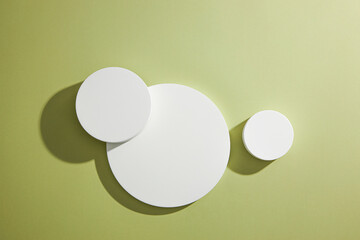 Top view of circle , square white podium ,  in green background and blank space for advertising , abstract content  