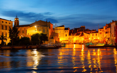 Naklejka premium Picturesque streets with backlit village of Martigues at night. France