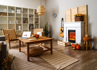 Interior of living room with autumn decor and fireplace