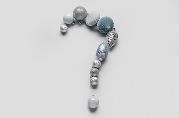 Question mark made of Christmas balls on light background