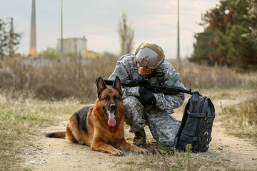 Soldier with military working dog outdoors