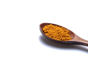Turmeric powder in a wooden spoon on a white background.