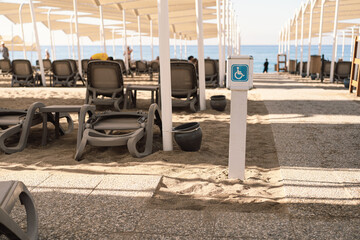 Disability sign on the sea beach. Beach places for people with disabilities. The sign for the disabled there are places for people with disabilities.