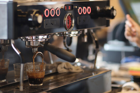 An espresso coffee maker makes black coffee. Coffee shop concept