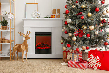 Interior of light living room with fireplace, Christmas tree and wooden reindeer