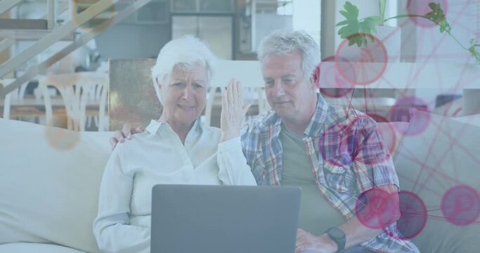 Animation of network of connections over senior caucasian couple using laptop