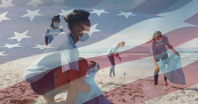 Animation of flag of united states of america over people in face masks cleaning beach