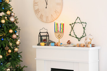 Beautiful decorations for Hanukkah celebration on fireplace in room