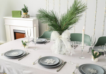 Fototapeta na wymiar Dining table with beautiful setting for Christmas celebration in festive room