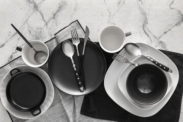 Set of stylish dinnerware on light background