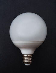 A high power LED bulb over the dark background. Close-up.