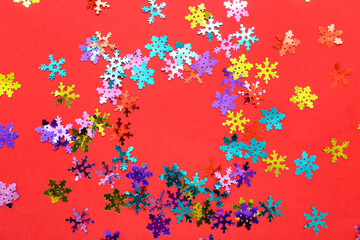 Frame made of beautiful confetti on red background