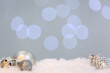 Christmas balls on snow against blurred lights