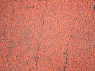 Orange-toned cement walls with old marks.