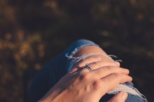 Beautiful wedding ring set on hand of young adult female glowing in the sun light. 
