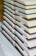 open hardcover books are stacked vertically on top of each other. The concept of loving books, reading books