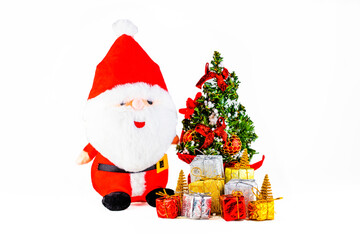Christmas Concept of generic soft toy of Santa Clause with Christmas tree and gifts on white background