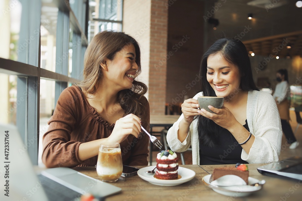 Wall mural two women drinking coffee in cafe steadicam shot