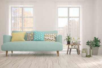 Stylish room in white color with sofa and autumn landscape in window. Scandinavian interior design. 3D illustration