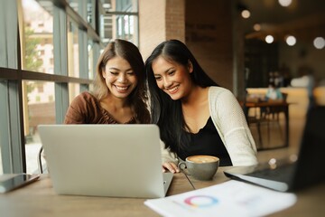 two women using laptop in cafe steadicam shot