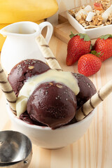 Açaí ice cream with condensed milk, strawberry, banana and granola.