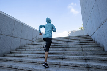 Fitness sports woman running up stairs in city