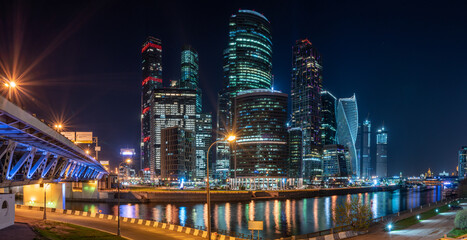 The scyscrapers of the Moscow City at night and the Dorogomilovsky bridge with illumination.