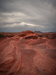 View of Wavy Stones Made with Red Rock, storm clouds in the sky, Arches National Park, Utah, USA
