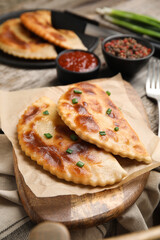 Delicious fried chebureki served on wooden table