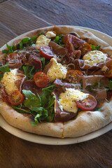Pizza with Tomatoes, Prosciutto, Arugula and Mozzarella