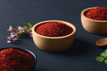 Korean red chili powder in a bowl on black background , Chili flakes