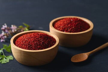Obraz na płótnie Canvas Korean red chili powder in a bowl on black background , Chili flakes