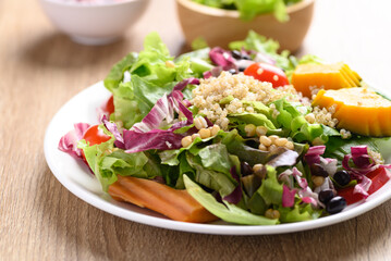 Fresh organic vegetables with quinoa salad on wooden background, Healthy Vegan food