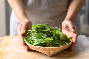Fresh organic chayote shoot leaf in a basket prepare for cooking