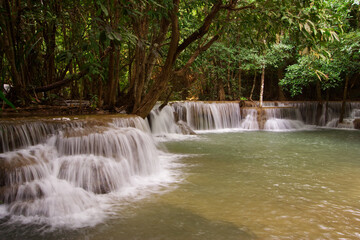 The scenery of waterfall in layers with trees in the jungle from Thailand.