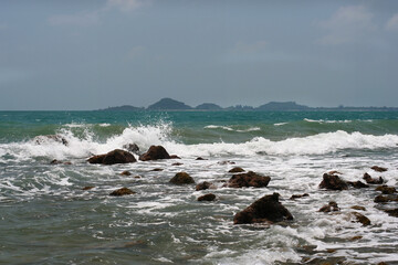 The scenery of rocks in the sea with white waves and not clear sky from south of Thailand.