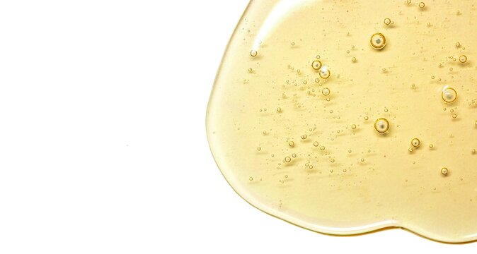 big size macro photo yellow gel texture with bubbles. Oil for skin. Clear cosmetic liquid gel swatch isolated on white background, banner format isolated with free space for text