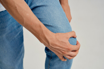 man holding his knee pain injury health problems