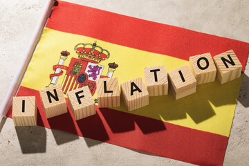 Spanish flag and wooden cubes with text on an abstract background, concept on the topic of...