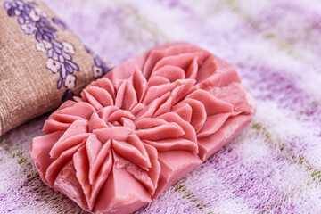 Handicraft soap carved in beautiful flower in soft bath blurred background
