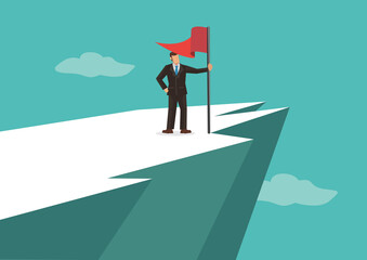 Businessman at the top of the mountain peak with a red flag