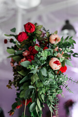 flower arrangement close-up. different colors of scarlet and red on metal structures in the white hall. The concept of a holiday and celebration.