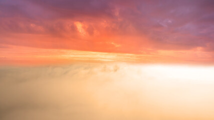 Fototapeta na wymiar Orange sky above the clouds